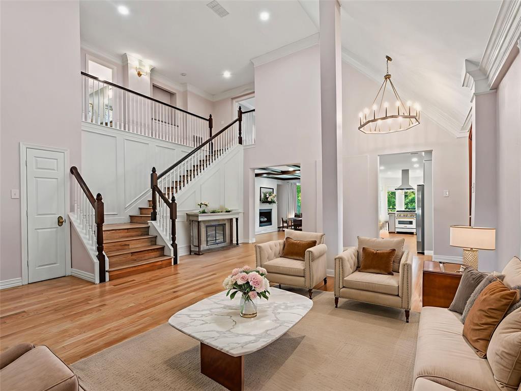 153 Meadowcreek Road Coppell, TX 75019 - Photo 5 of 35 Living room with ornamental molding, a high ceiling, light wood-type flooring, and suspended lighting
