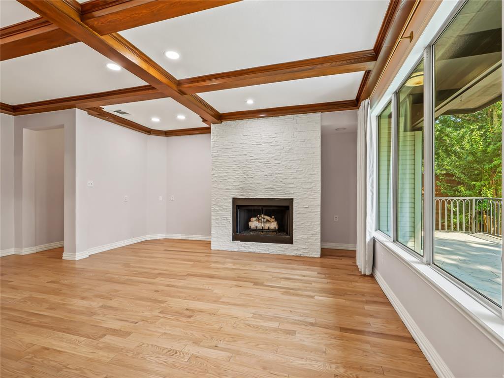 153 Meadowcreek Road Coppell, TX 75019 - Photo 8 of 35 Unfurnished living room featuring coffered ceiling, light wood-style floors, and a fireplace