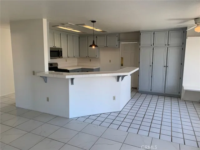 a kitchen with a sink a stove and cabinets