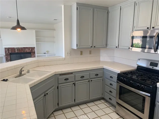 a kitchen with cabinets appliances and a sink