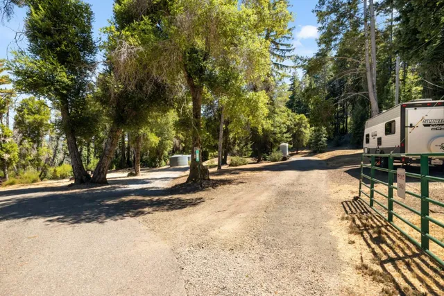 a view of a street with a building and trees in the background