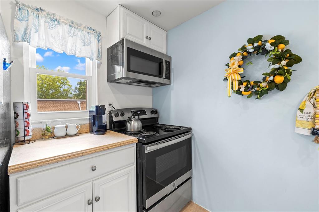 12760 Indian Rocks Road, Unit 107 Largo, FL 33774 - Photo 13 of 39 a kitchen with a sink cabinets and a window
