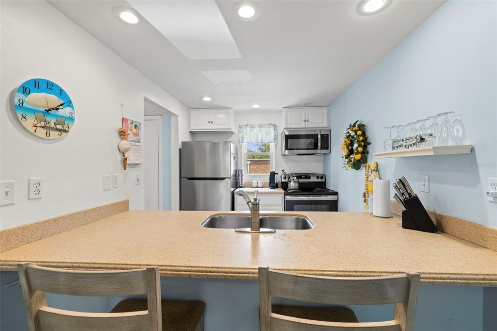 12760 Indian Rocks Road, Unit 107 Largo, FL 33774 - Photo 15 of 39 a kitchen with a refrigerator and a stove