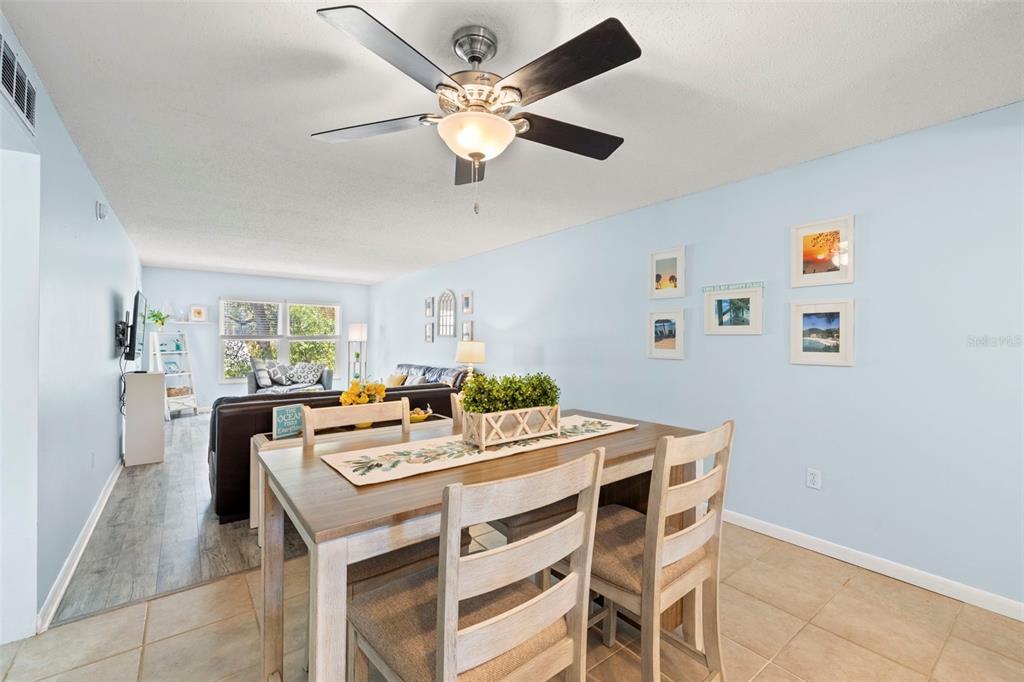 12760 Indian Rocks Road, Unit 107 Largo, FL 33774 - Photo 16 of 39 a view of a dining room with furniture and a chandelier fan