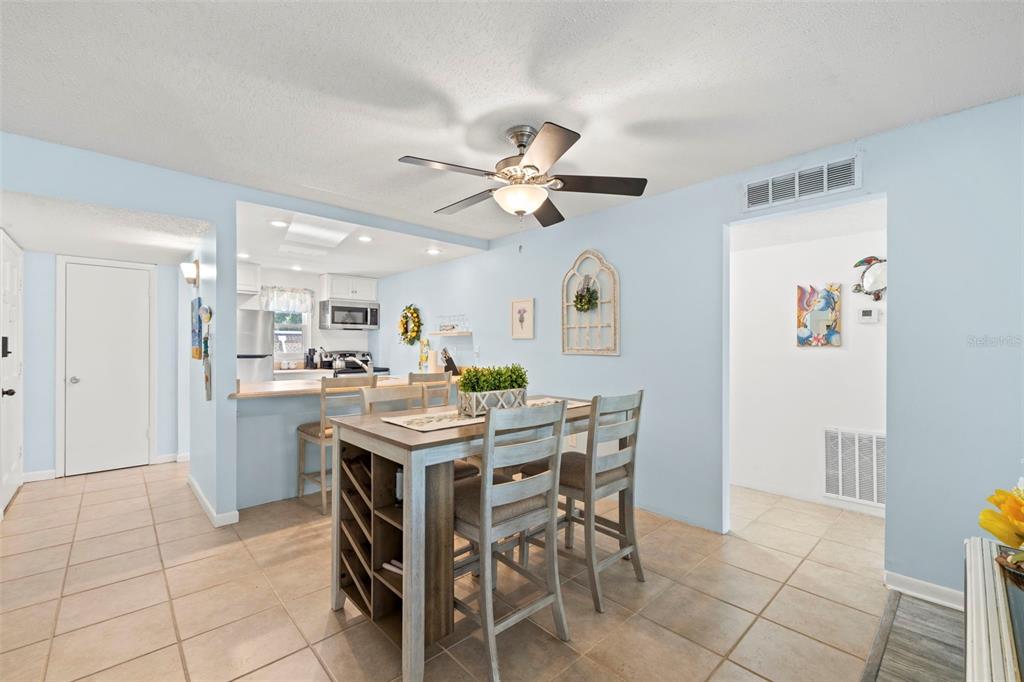 12760 Indian Rocks Road, Unit 107 Largo, FL 33774 - Photo 17 of 39 a kitchen with a table and chairs in it