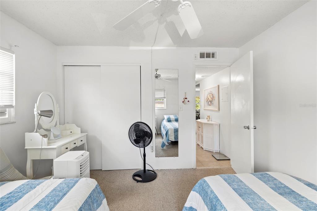12760 Indian Rocks Road, Unit 107 Largo, FL 33774 - Photo 24 of 39 a bedroom with a bed and a chandelier