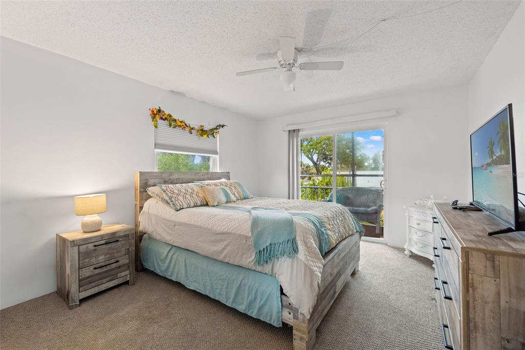 12760 Indian Rocks Road, Unit 107 Largo, FL 33774 - Photo 26 of 39 a bedroom with a bed and a flat screen tv