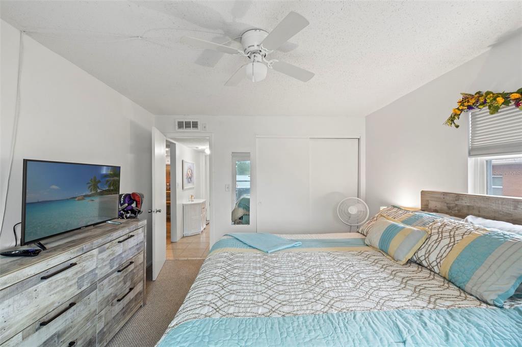 12760 Indian Rocks Road, Unit 107 Largo, FL 33774 - Photo 29 of 39 a bedroom with a bed and a flat screen tv