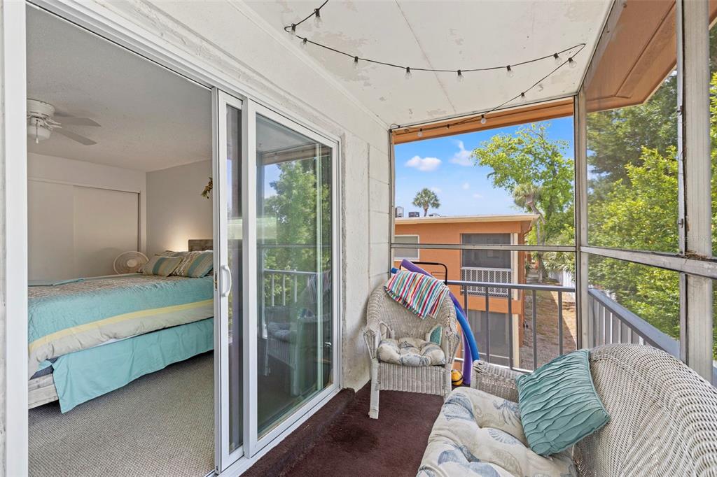 12760 Indian Rocks Road, Unit 107 Largo, FL 33774 - Photo 31 of 39 a living room with a floor to ceiling window and wooden floor