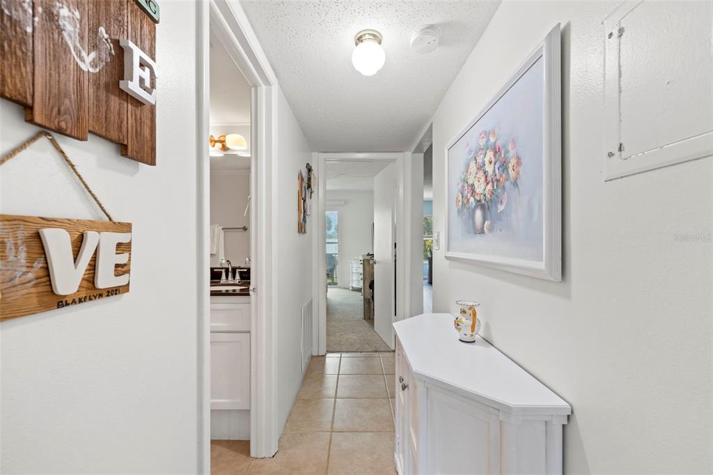 12760 Indian Rocks Road, Unit 107 Largo, FL 33774 - Photo 6 of 39 a bathroom with a sink a mirror and a shower