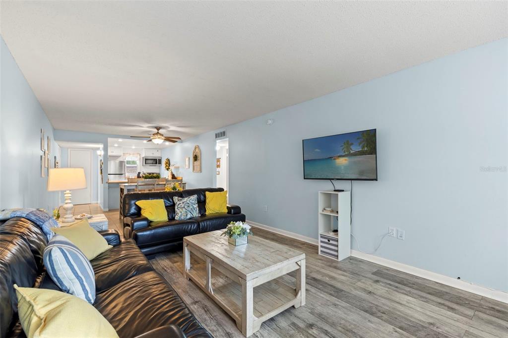 12760 Indian Rocks Road, Unit 107 Largo, FL 33774 - Photo 7 of 39 a living room with furniture and a flat screen tv