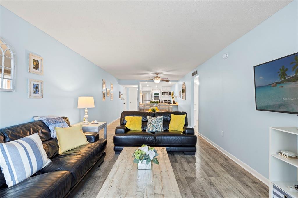 12760 Indian Rocks Road, Unit 107 Largo, FL 33774 - Photo 8 of 39 a living room with furniture and a flat screen tv