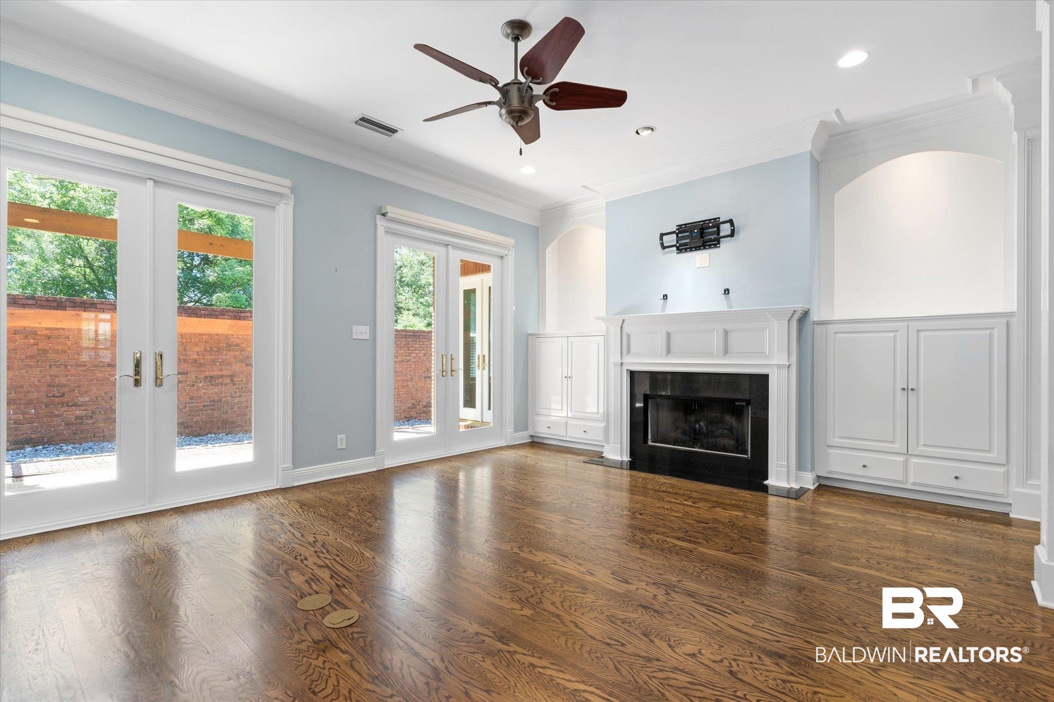 107 Fielding Place Mobile, AL 36608 - Photo 4 of 27 Unfurnished living room featuring french doors, a fireplace, ceiling fan, wood finished floors, and recessed lighting
