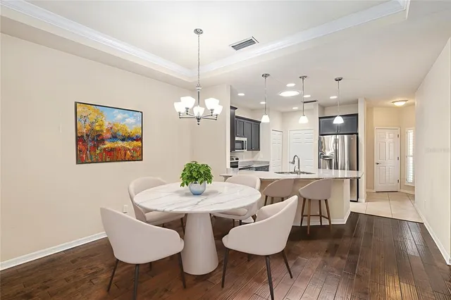 a view of a dining room with furniture and wooden floor