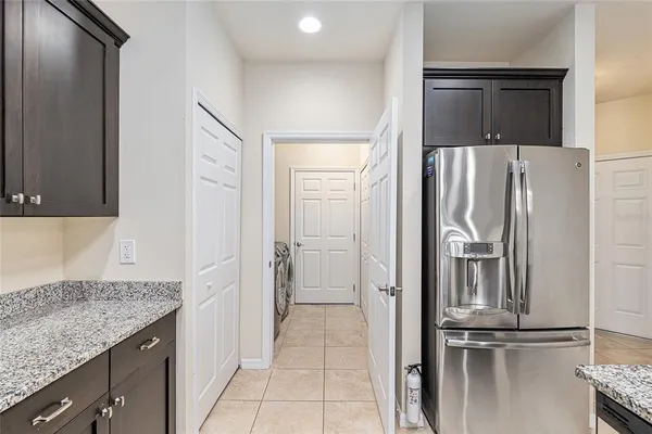 a kitchen with a refrigerator and cabinets