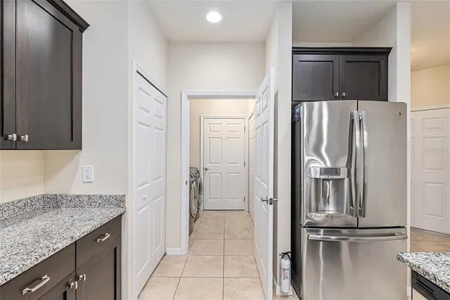 a kitchen with a refrigerator and cabinets