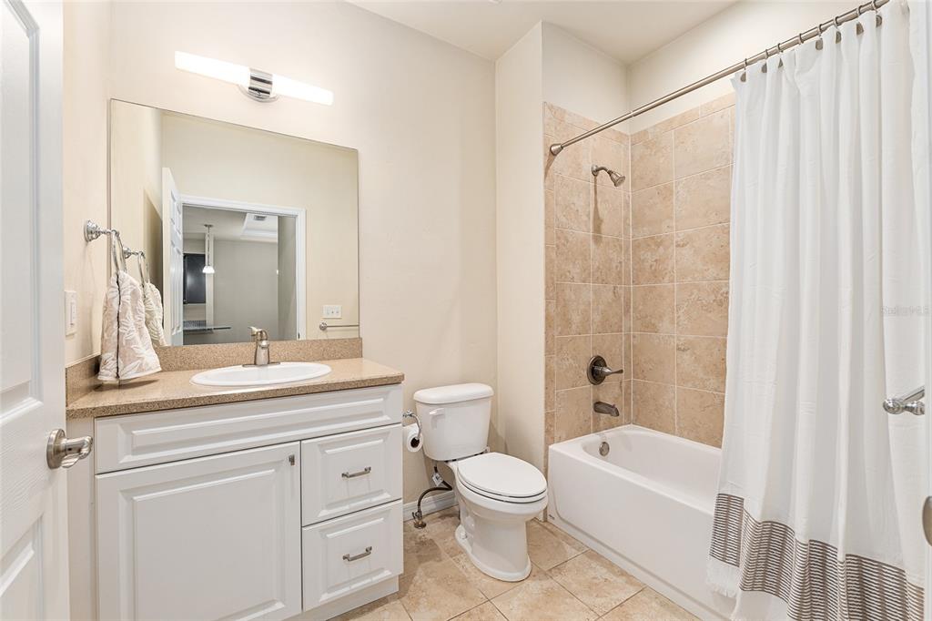 12731 Northwest 12th Road Newberry, FL 32669 - Photo 21 of 33 a bathroom with a granite countertop sink a toilet and a bathtub