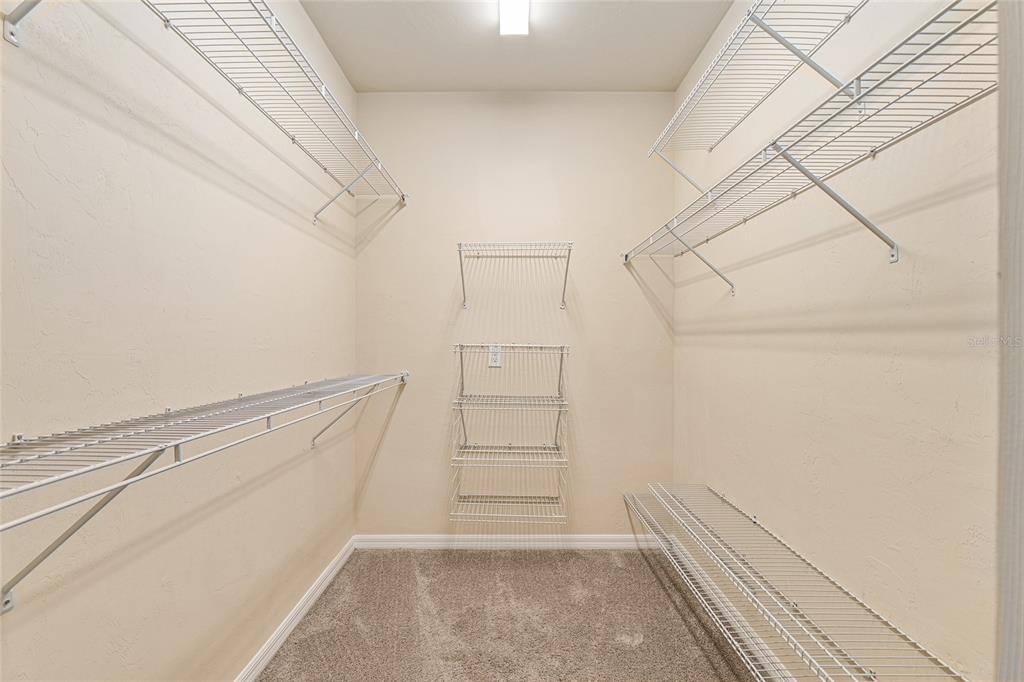 12731 Northwest 12th Road Newberry, FL 32669 - Photo 26 of 33 a view of walk in closet with empty racks