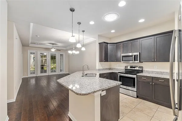 a kitchen with kitchen island granite countertop a sink and stove