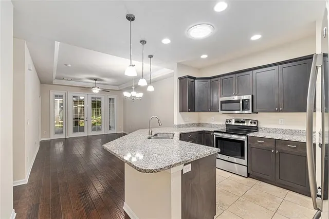 a kitchen with kitchen island granite countertop a sink and stove