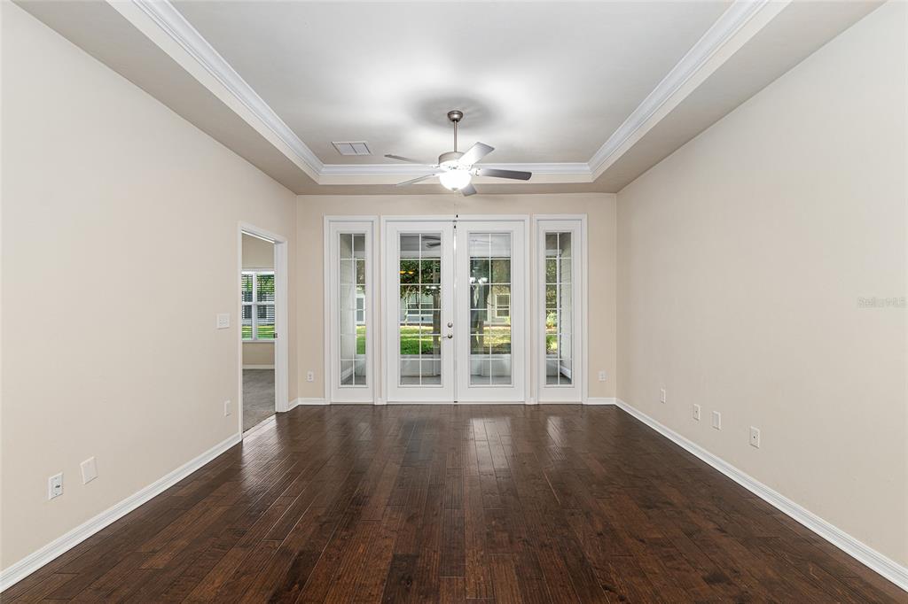 12731 Northwest 12th Road Newberry, FL 32669 - Photo 8 of 33 wooden floor in an empty room with a window