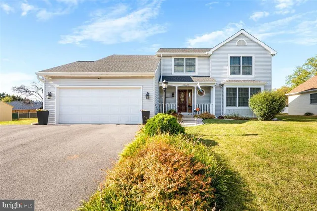 a front view of house with yard and trees around