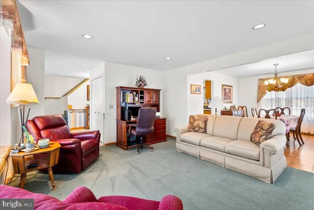a living room with furniture a rug and a large window