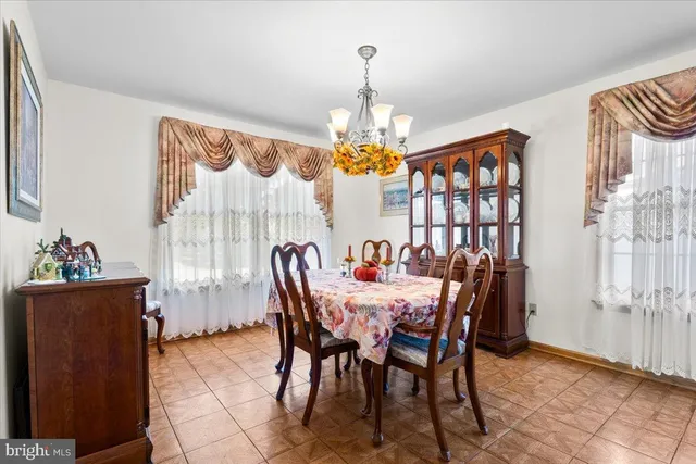 a view of a dining room with furniture and a chandelier