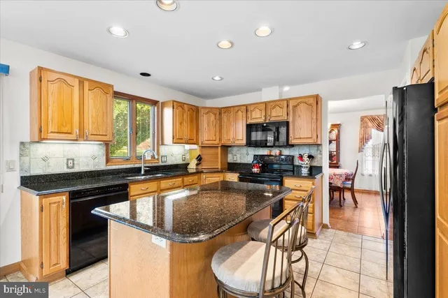 a kitchen with granite countertop lots of counter top space and stainless steel appliances