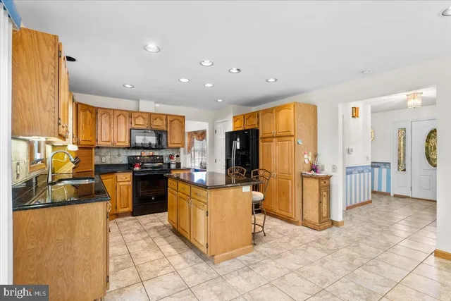 a kitchen with refrigerator and cabinets