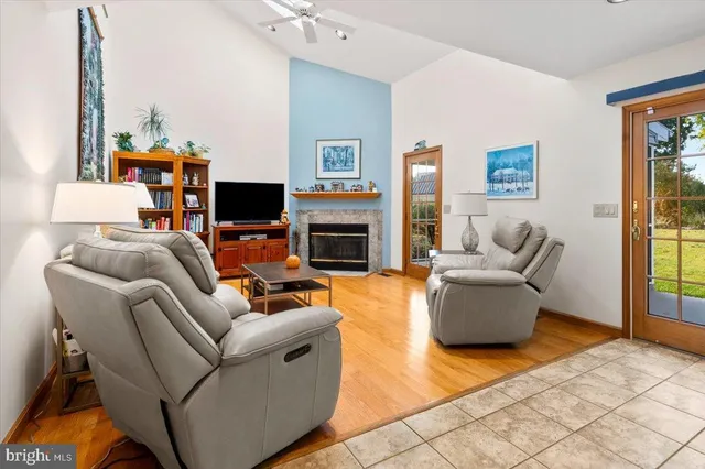 a living room with fireplace furniture and a flat screen tv