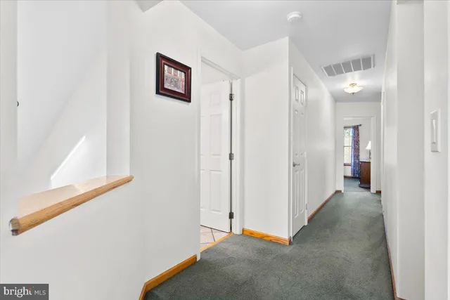 a view of a hallway with two rooms