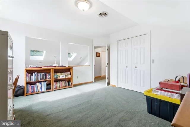 a spacious bedroom with a bed and a cabinets