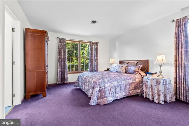 a bedroom with a large bed and a dresser