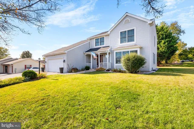 a front view of house with yard and swimming pool