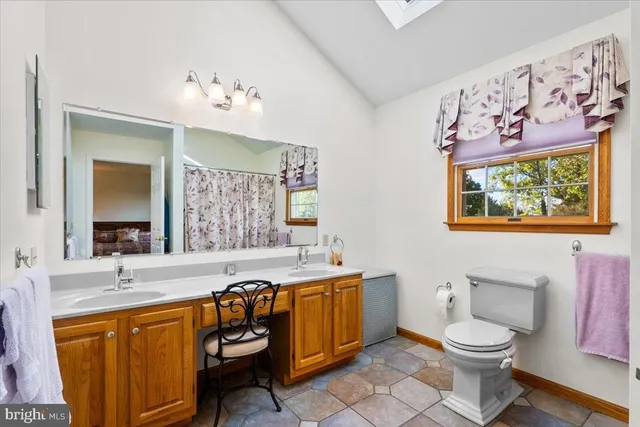 a bedroom with a bed table closet and a flat tv screen