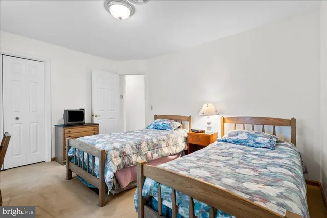 a bedroom with a bed and a chair