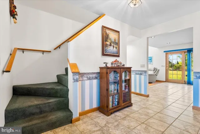 a living room with furniture and a baby crib