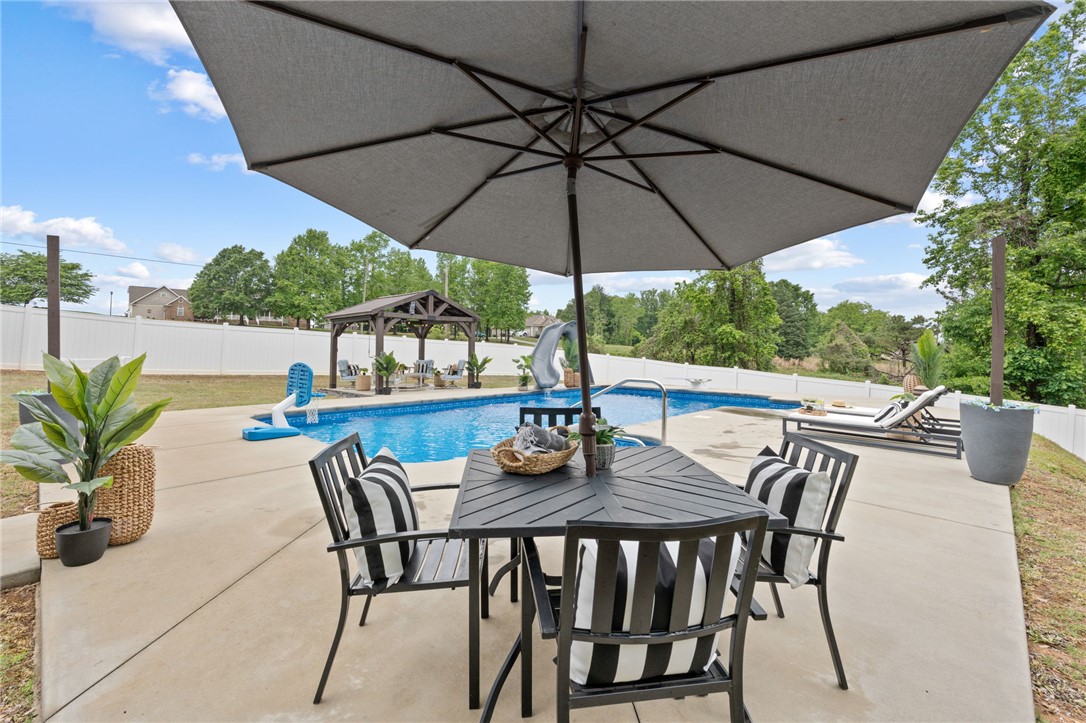1050 Old Dacusville Road Easley, SC 29640 - Photo 26 of 33 This private outdoor oasis features a refreshing pool, inviting patio, and a serene gazebo perfect for relaxation.