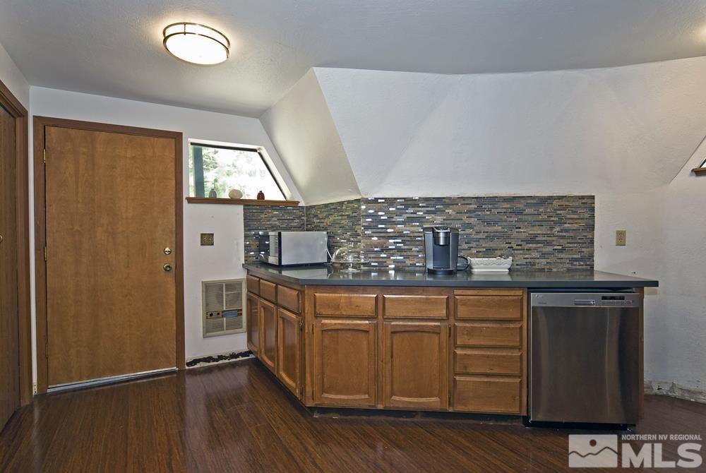 820 Hot Springs Road Markleeville, CA 96120 - Photo 23 of 36 a kitchen with stainless steel appliances granite countertop a sink and wooden cabinets