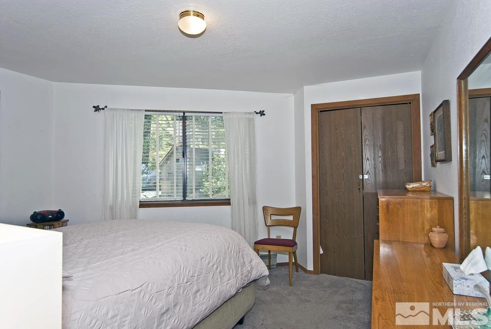 820 Hot Springs Road Markleeville, CA 96120 - Photo 30 of 36 a bedroom with a bed and wooden floor
