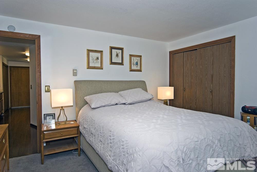 820 Hot Springs Road Markleeville, CA 96120 - Photo 31 of 36 a bedroom with a bed and a night stand