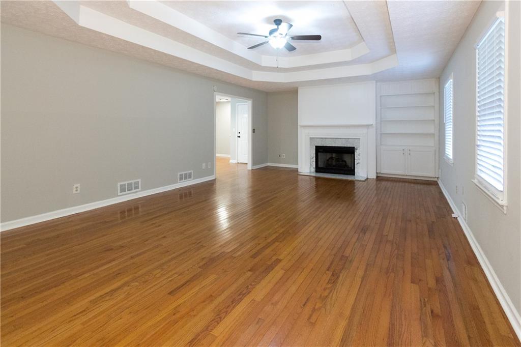 374 McGiboney Road Covington, GA 30016 - Photo 6 of 29 wooden floor fireplace and windows in an empty room
