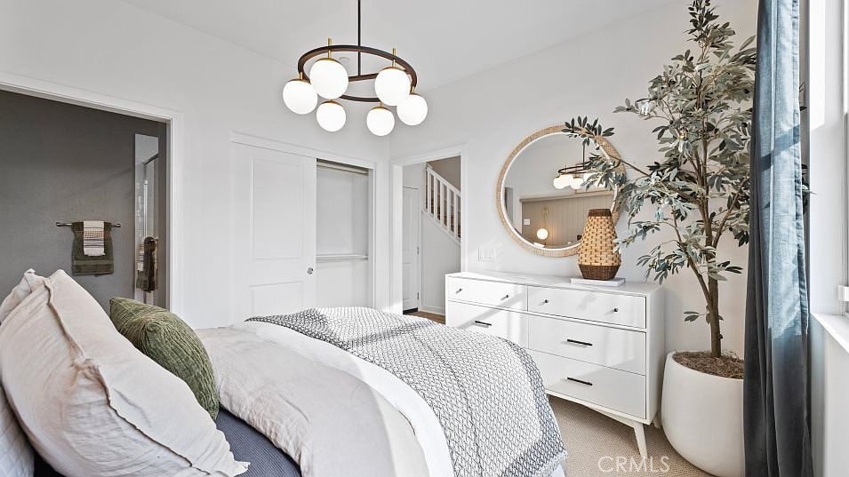 501 Tamarind Way, Unit F West Covina, CA 91791 - Photo 2 of 7 a bedroom with bed and a chandelier