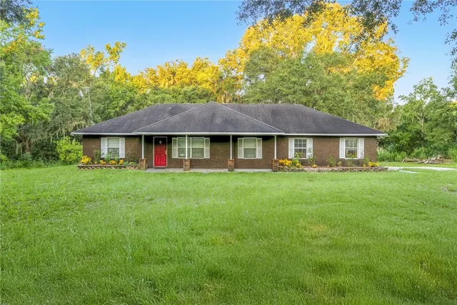 a view of house with a yard