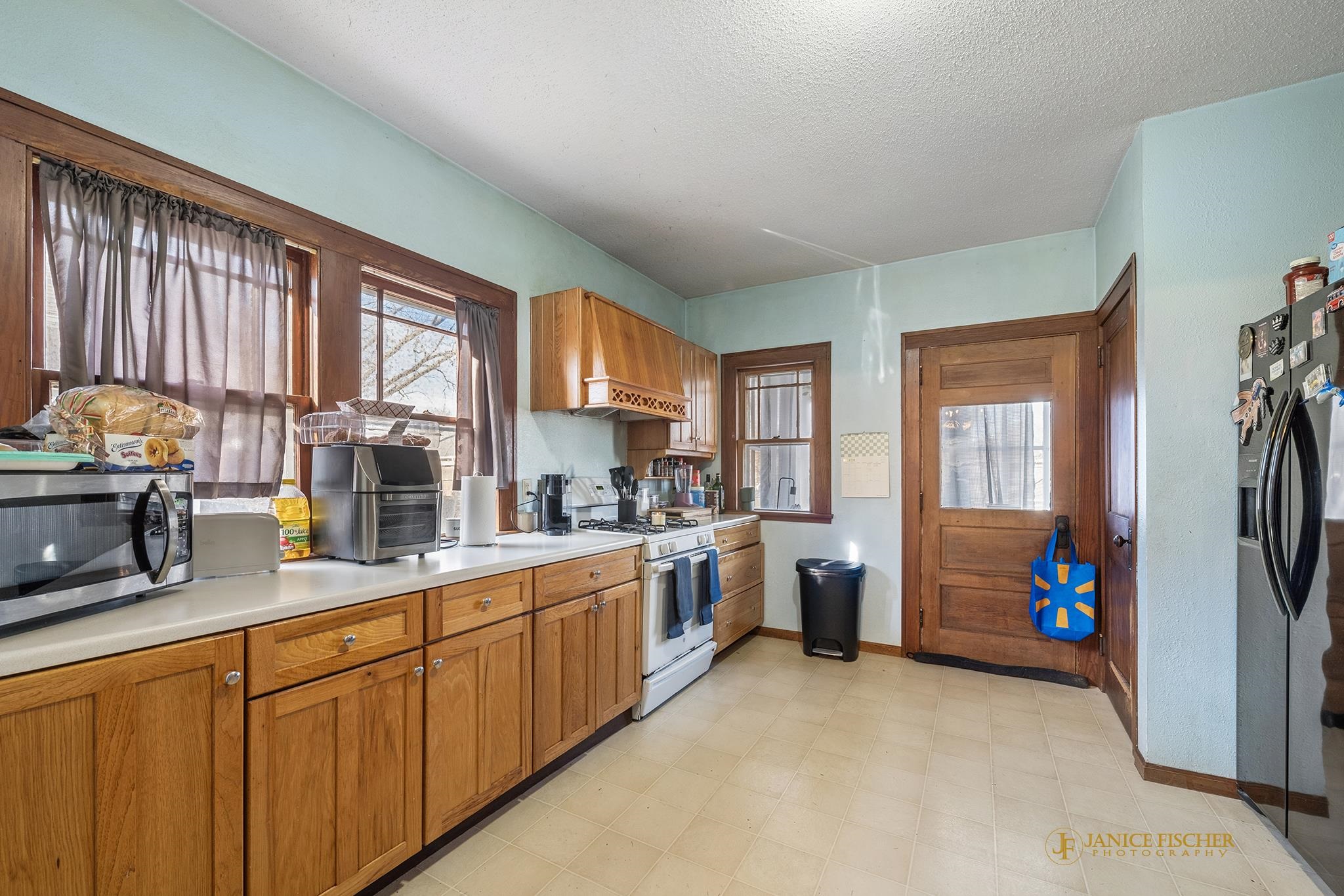 522 Rome Avenue Rockford, IL 61107 - Photo 5 of 13 a kitchen that has a lot of cabinets a sink and wooden floor