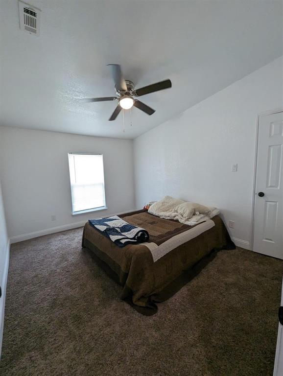 701 Rumage Road Jacksboro, TX 76458 - Photo 8 of 15 a bed sitting in a bedroom next to a window