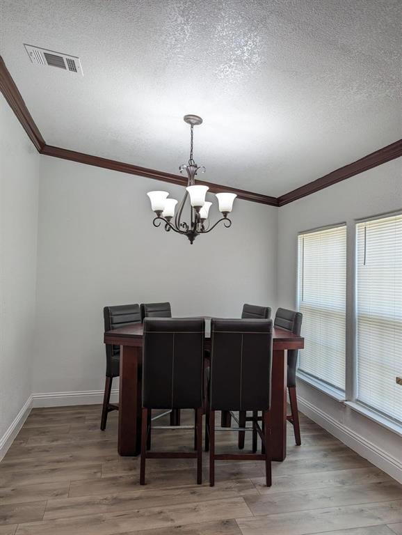701 Rumage Road Jacksboro, TX 76458 - Photo 10 of 15 a view of a dining room with furniture window and wooden floor