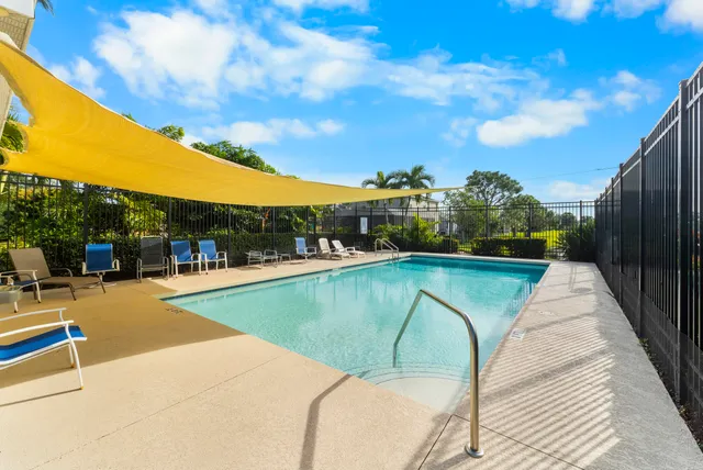 an aerial view of a house with a garden and lake view