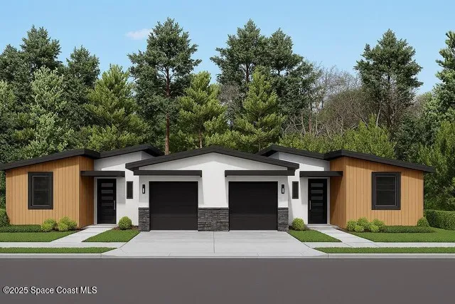 a front view of a house with a yard and trees